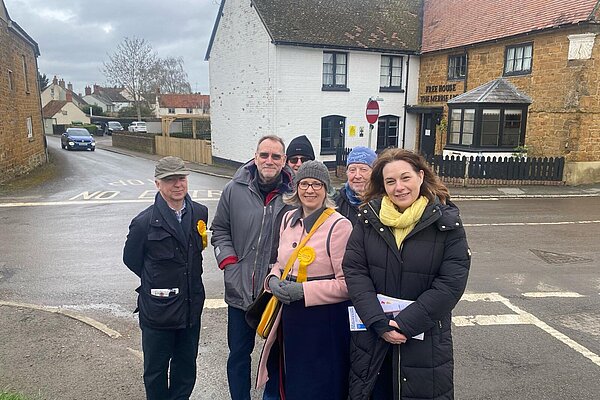 Jenny Wilkinson with fellow canvassers in Fenny Compton with Merrie Lion Pub behind