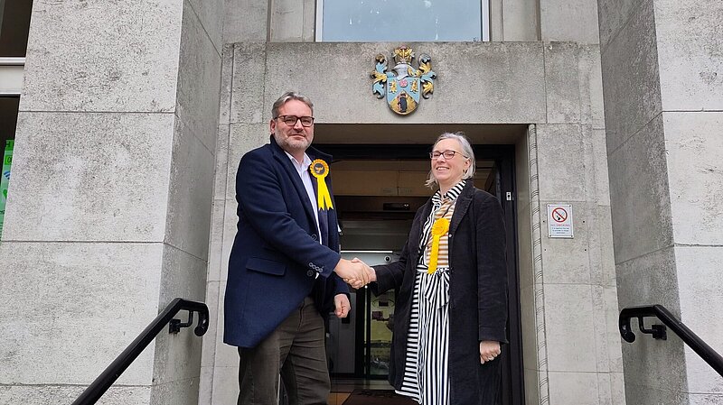 Photo of Newly elected Rugby Borough Councillor Jon Bennett with Jenny Wilkinson, Parliamentary Candidate for Kenilworth & Southam, after the count. They are the steps of the Benn Hall where the count took place.