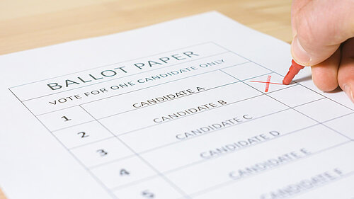 A mockup ballot paper with an X being marked next to a candidate